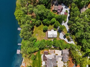 Vista aérea de una zona residencial con casas, un camino de entrada y una masa de agua.