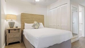 A bedroom with a bed, nightstand, lamp, ceiling fan, and white closets. - SPECIAL OFFER Pay for 5 nights get 7 nights
Caloosa Cove Resort  Islamorada Key (Islamorada)