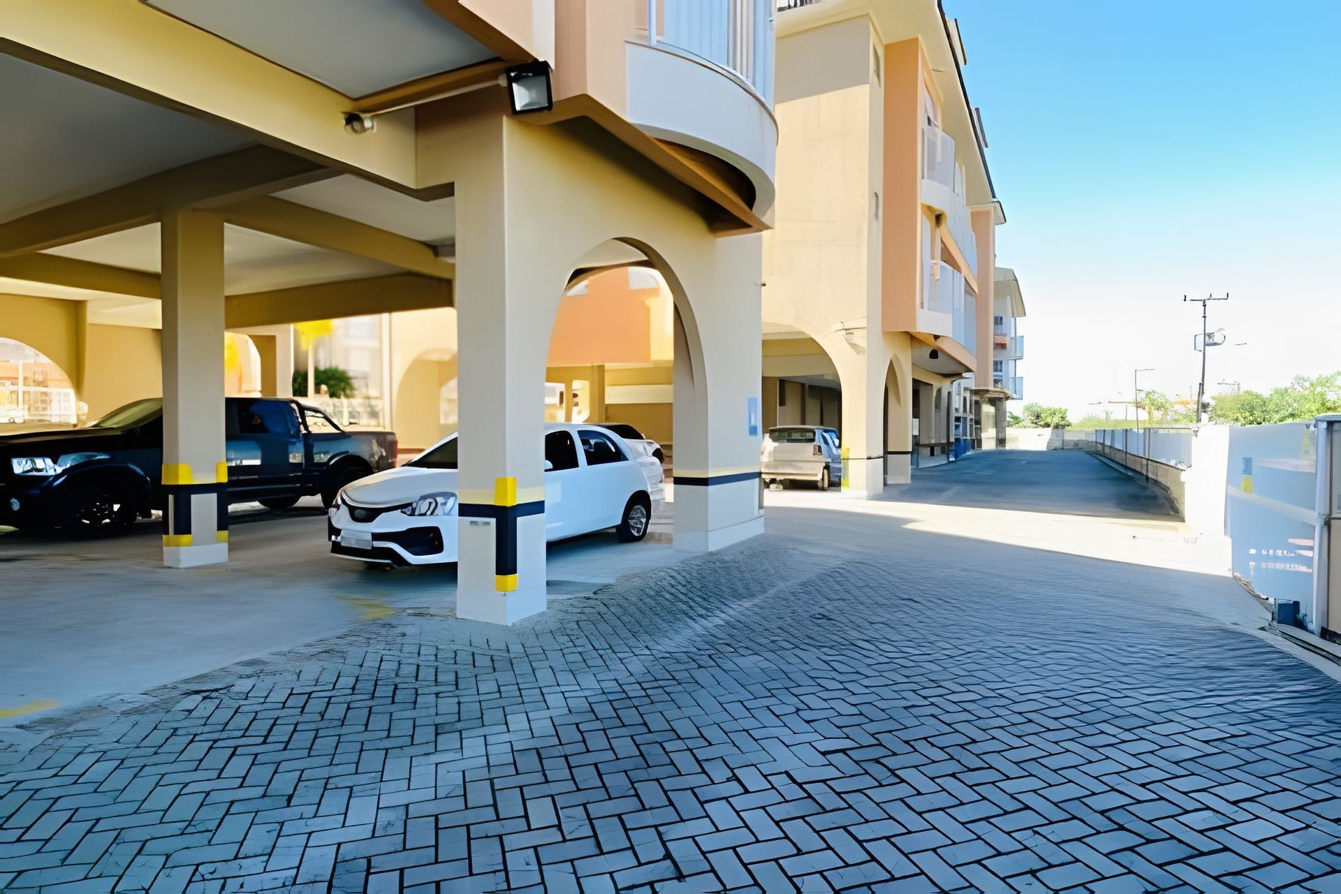 A parking garage with multiple levels and a covered walkway.
