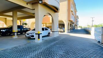 A parking garage with multiple levels and a covered walkway.