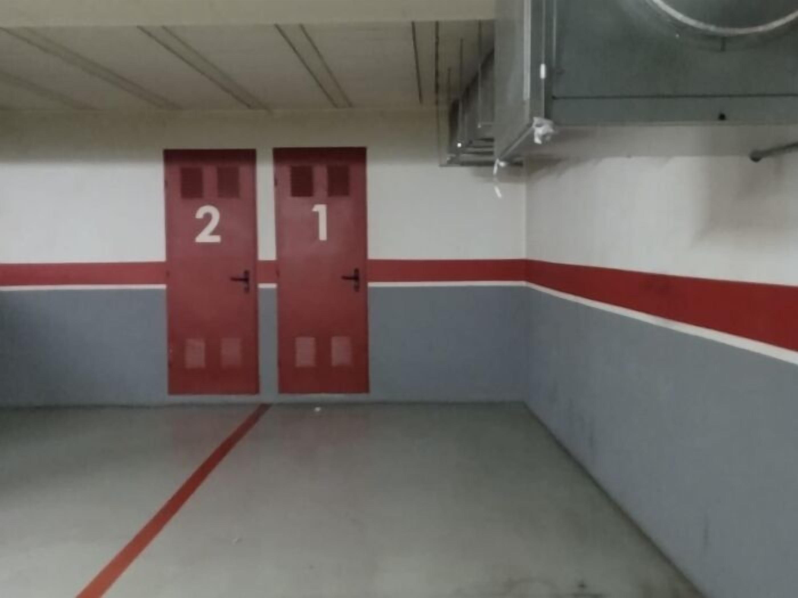 A corridor with two red doors marked with numbers 1 and 2.