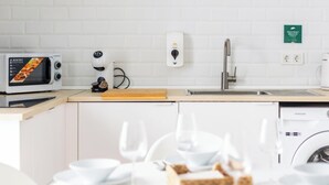 A modern kitchen with a microwave, coffee maker, and a sink. - Bajo Teatro Falla by Cadiz Time (Ciudad de Cádiz)
