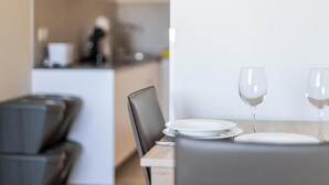 A dining area with a table set for two, two wine glasses, and a plate. - Delfin Azul 2 FREE PARKING by Cadiz Time (Cádiz)