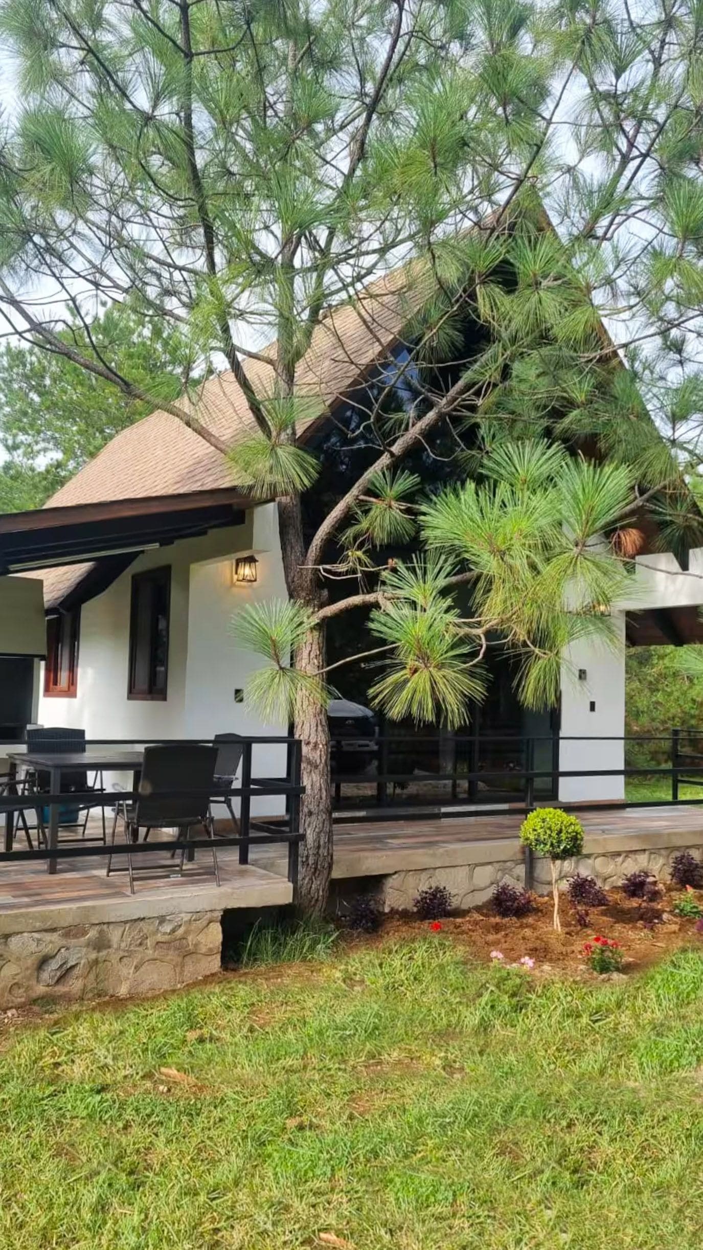 A house with a covered patio, a dining table, and chairs.