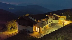 A modern house with a spacious patio, a large garage, and a view of the surrounding hills. - Apartment with views to the Picos de Europa 4 pax - 1 (Tollo)