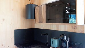 A compact kitchen with a microwave, toaster, and coffee maker.