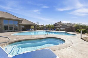 A swimming pool with two separate sections, lounge chairs, and a building with large windows. - Pool Getaway to Zion w/ Private Hot Tub & BBQ (Washington)