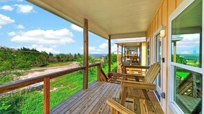 A wooden deck with outdoor furniture, a covered area, and a view of the beach and ocean. - Black Drum by Avantstay Water Views Wraparound Decks Pool Access Laguna Madre + Padre Island (Corpus Christi)