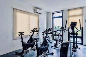 A gym with stationary bikes, a treadmill, and a rowing machine. -     “Modern 1BR Condo – Steps from Beaches & Airport” (Lapu-Lapu)