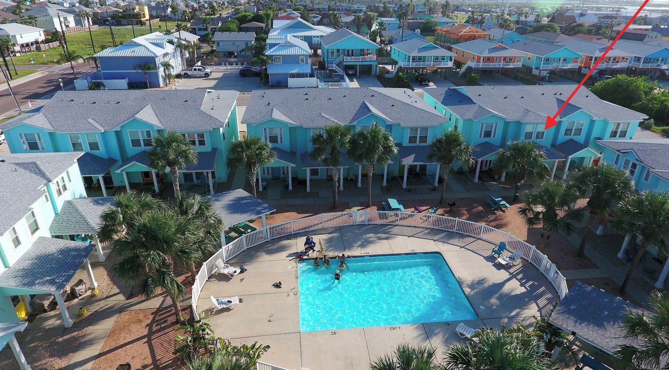 A residential area with a swimming pool surrounded by houses.