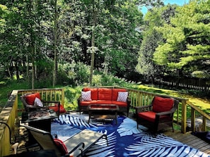 A deck with a sofa, chairs, and a table.