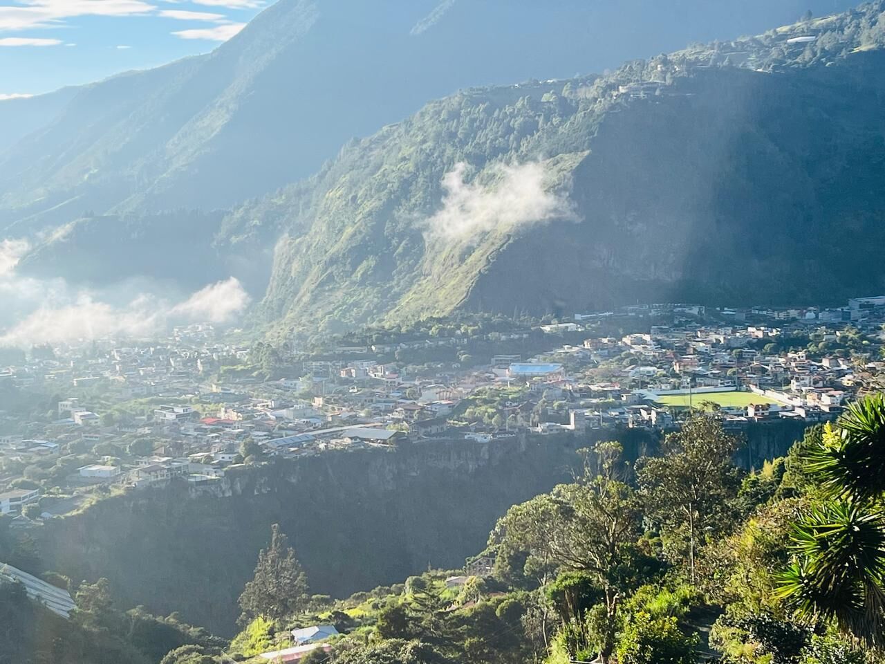A mountainous landscape with a town nestled in a valley.