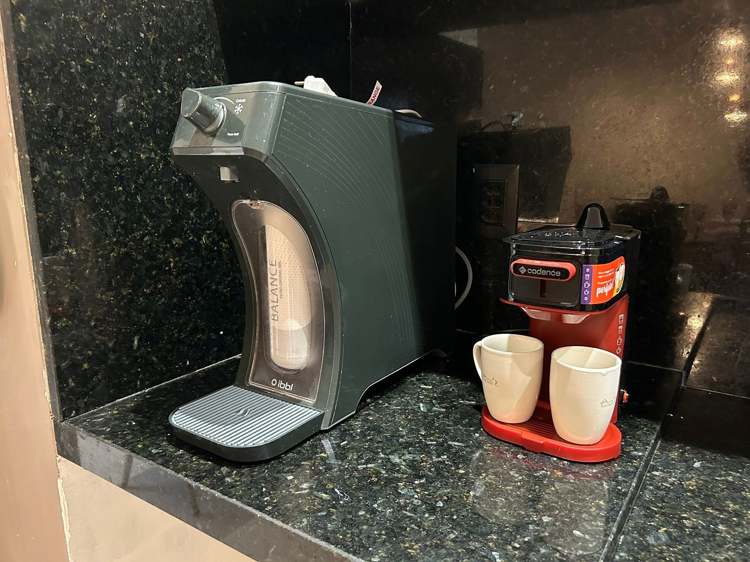 A coffee machine with two cups on a countertop.
