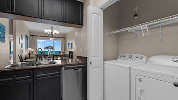 A kitchen with a dishwasher, a built-in oven, and a countertop with a sink.