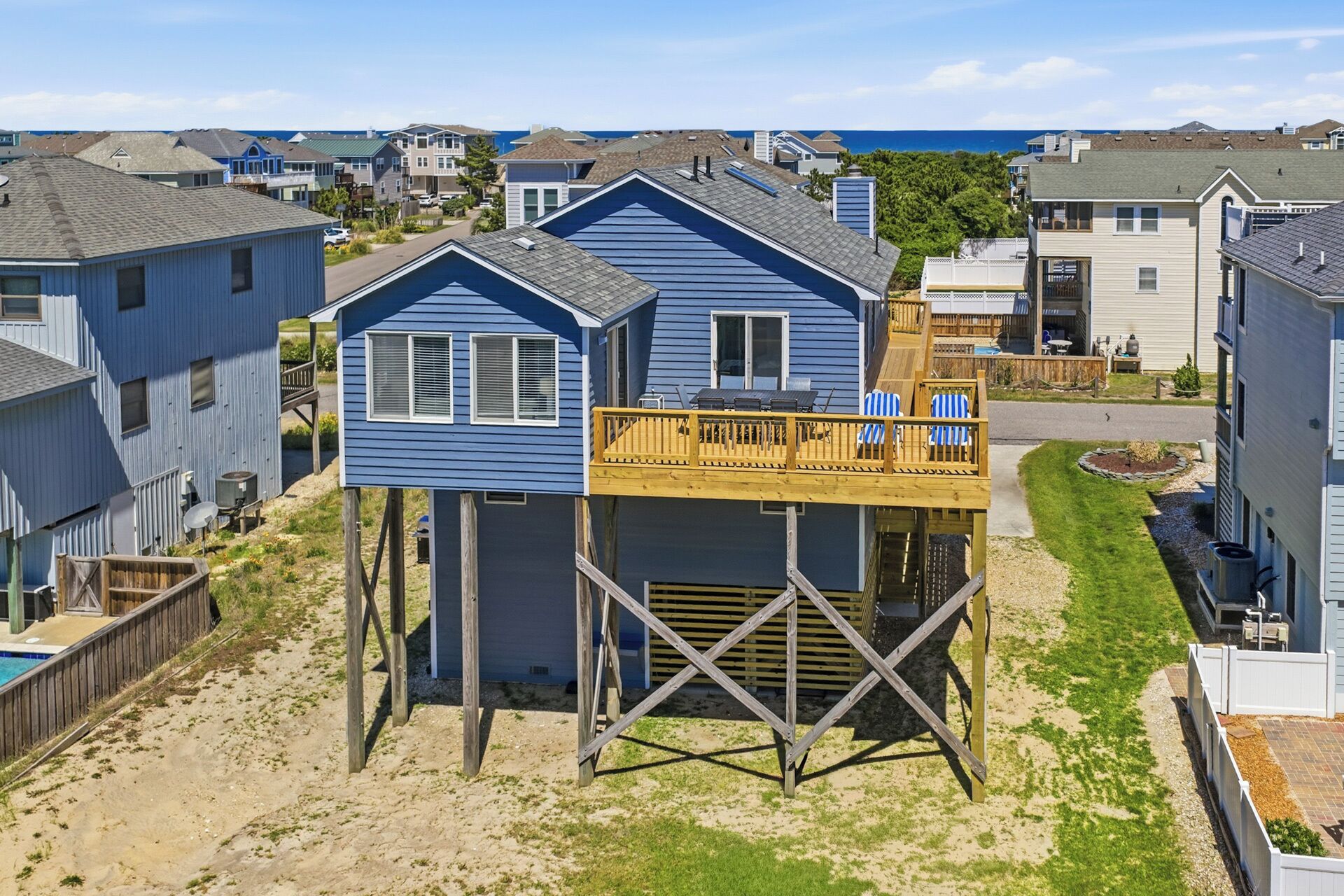 A beachfront house with a raised deck and a small pool.