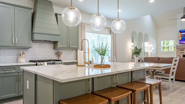 A kitchen with a large island, bar stools, and pendant lighting. - Pet-Friendly 4BR 5 Min to LakePoint with TV Room (Emerson)