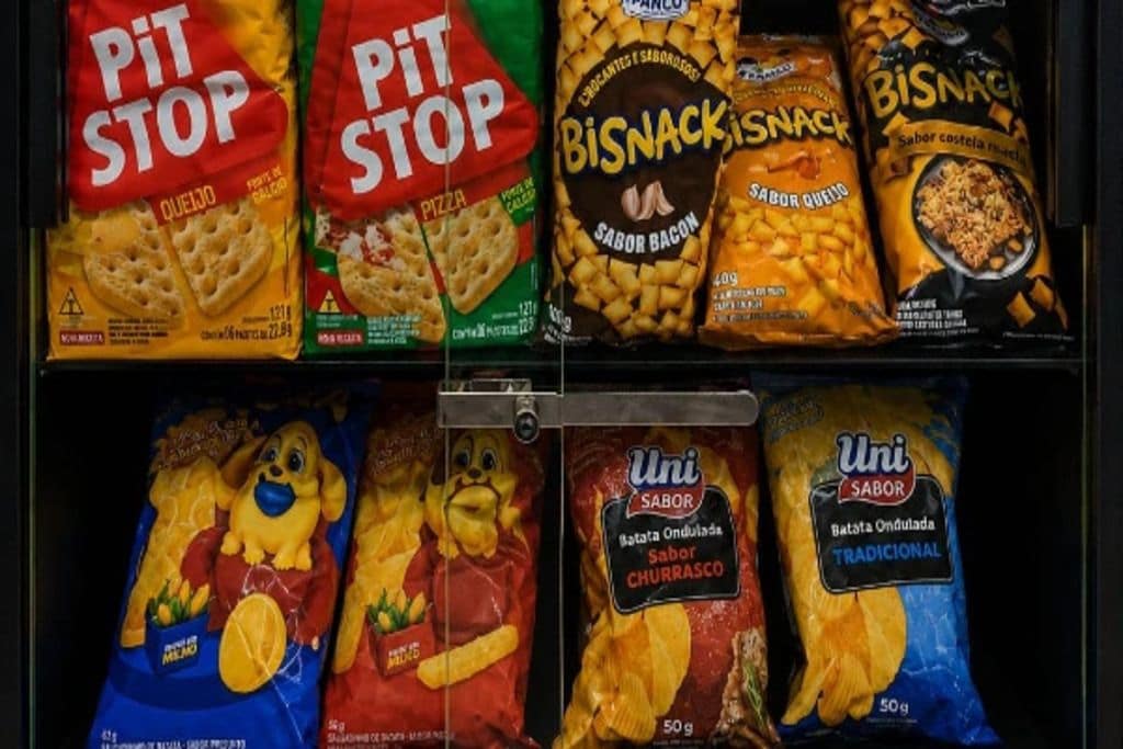 A refrigerated display with various snack products including 'PIT STOP' and 'BISNACKISNACK' brands.