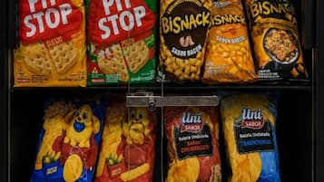 A refrigerated display with various snack products including 'PIT STOP' and 'BISNACKISNACK' brands.
