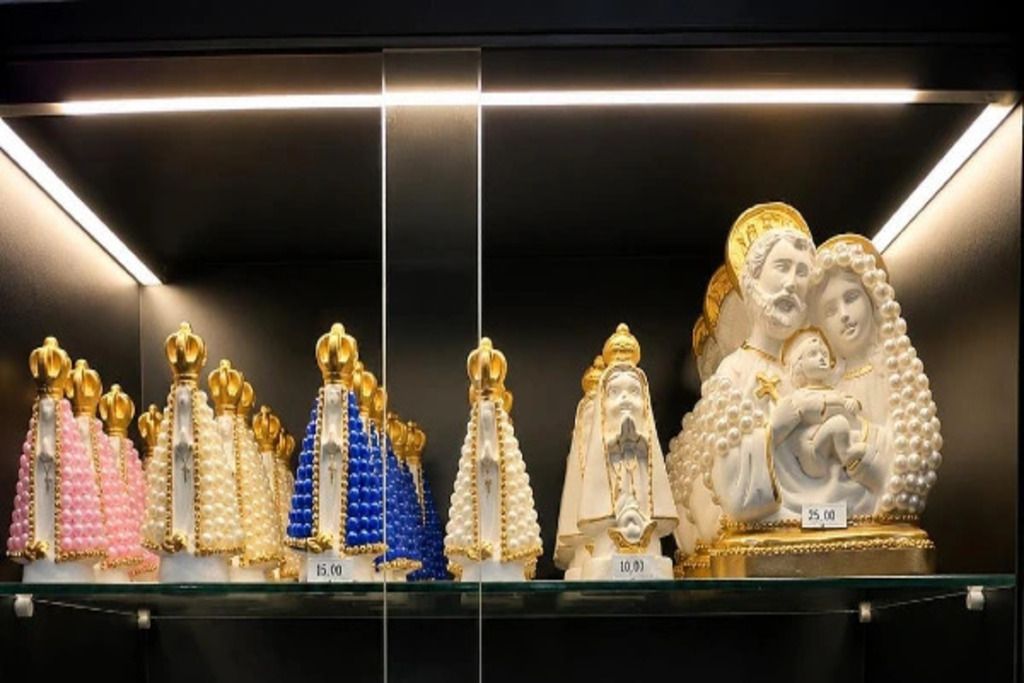 A display of religious statues with price tags.