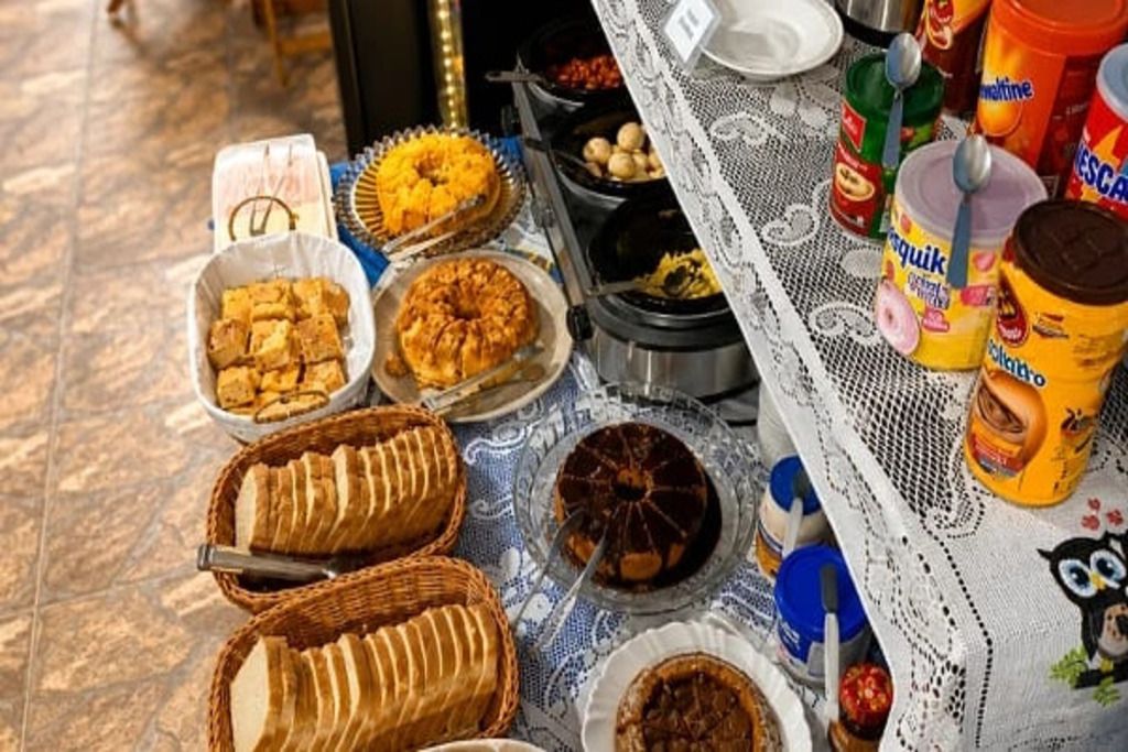 A buffet table with various food items and condiments.