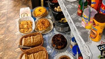 A buffet table with various food items and condiments.