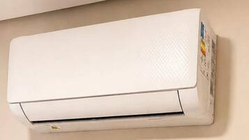 A white air conditioning unit mounted on a wall.