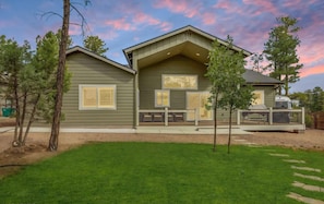 A two-story house with a covered porch, a garage, and a well-maintained lawn. - Modern Home Escape in the Pines - Family Friendly (Show Low)