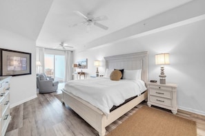 A bedroom with a bed, nightstands, a chair, a ceiling fan, and a window. - Dunes of Seagrove 302B - Gulf front with great views! (Santa Rosa Beach)