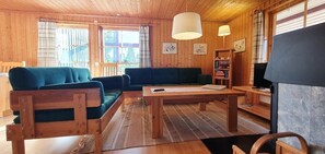 A wooden interior with a sofa, a table, and a bookshelf. - Sauna | Wi-Fi | Terrace | Wood stove | Cable TV (Lofsdalen)