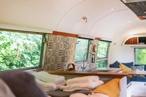 A compact kitchen with a sink, a window, and a patterned backsplash. - Sleeps 2 - Private Hot Tub - Fire Pit (Cardigan)