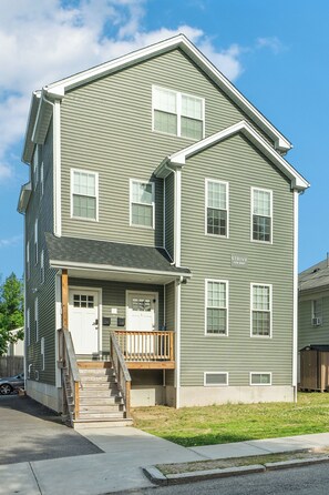 A two-story building with a front porch, a staircase, and a sign that reads 'STRIVE FOR RENT.' - RiverLight Retreat- Relaxing Getaway- Large Group, Near Providence College (Providence)