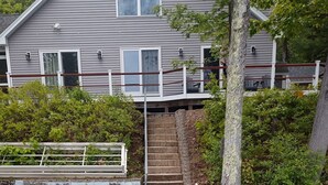 A wooden dock leading to a house with a stone staircase. - Charming Lakehouse in Peaceful Tilton on Silverlake! (Tilton)