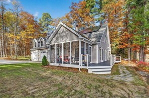 A two-story house with a covered porch, a garage, and a small front yard.