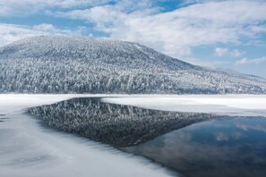 Un lago helado con una montaña al fondo.