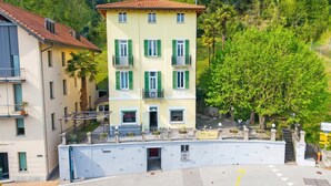 A multi-story building with balconies, a sign reading 'Villa Lygia,' and a surrounding lush green hillside. - Agra 8 (Lugano), double, PrivateBathroom, Agra -Lugano, Switzerland (Agra -Lugano)