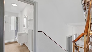 A staircase leading to a bathroom with a shower, toilet, and sink. - Agra 6 (Lugano), single, Shared Bathroom, Agra -Lugano, Switzerland (Agra -Lugano)