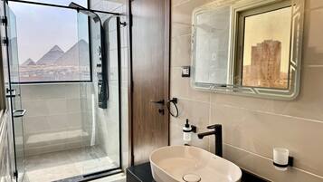 Shower, hair dryer, towels, toilet paper