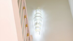 A modern chandelier with multiple tiers and gold accents. - The Pivot Suite Ben Thanh - District 1 (Ho Chi Minh City)