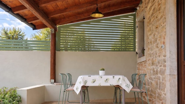 An outdoor patio with a table, chairs, and a hanging light fixture. - Dariocchi by Interhome (Poreč/Kaštelir)