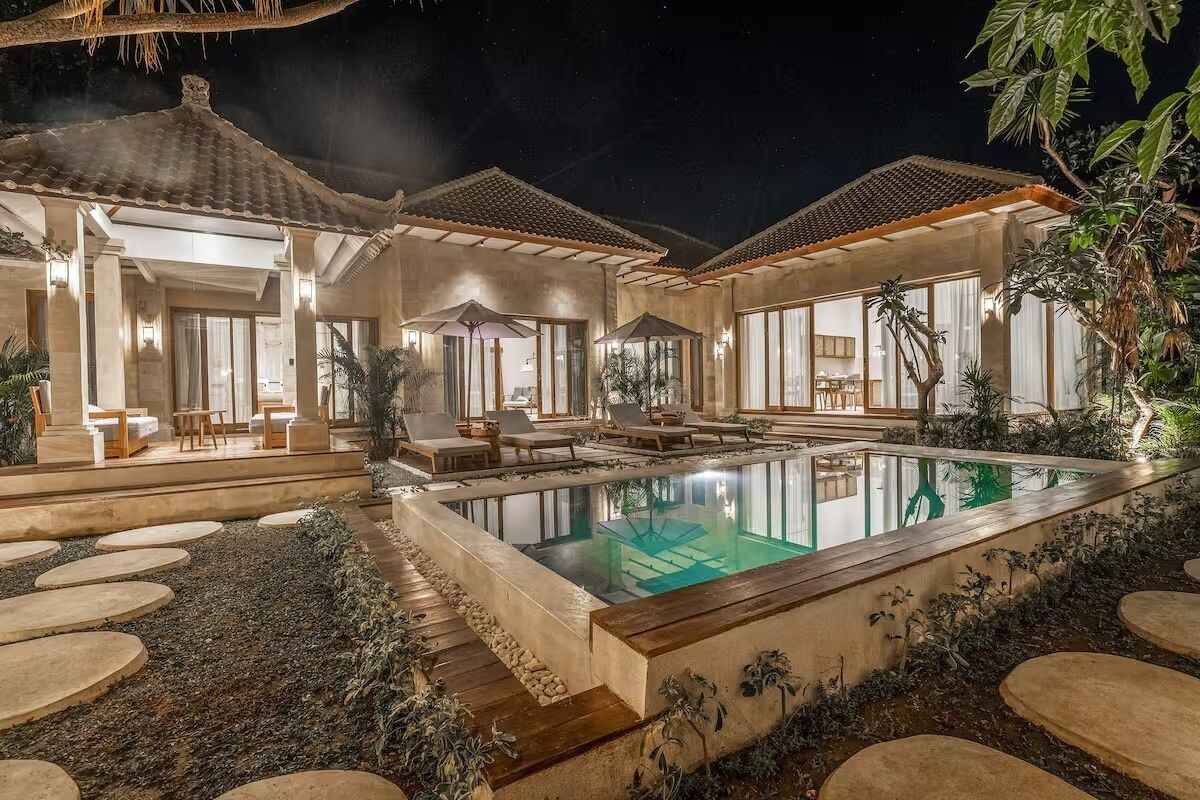 A poolside area with lounge chairs and a swimming pool.