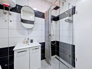 A modern bathroom with a white sink, mirror, and shower enclosure. - Mary & Klara by Interhome (Trogir/Okrug Gornji)