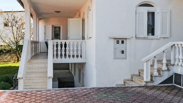 A two-story building with a balcony, a staircase, and a small door with shutters. - Apartment Jako by Interhome (Trogir/Slatine)