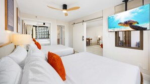 A hotel room with two beds, a ceiling fan, a TV, and a view of the ocean. - 14Fl Renovated Ocean View with Pool & Parking (Honolulu)