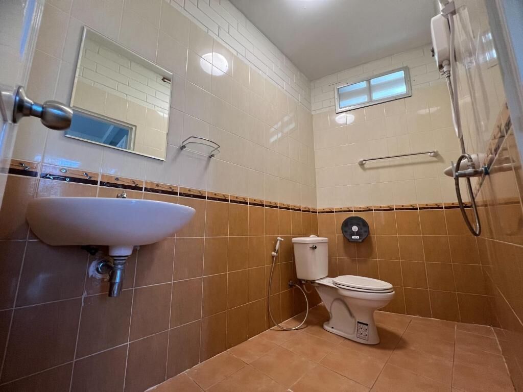 A bathroom with a sink, toilet, and shower.