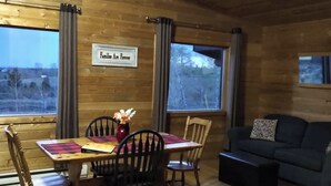 Un interior de madera con una mesa de comedor, sillas, un sofá y un cartel que dice 'Families Are Forever'.