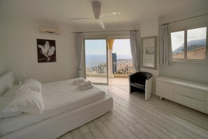 A hotel room with a bed, a chair, a vanity, and a balcony with a city view. - FRGK Magnificent See View Villa with Monaco backgr (Beausoleil)