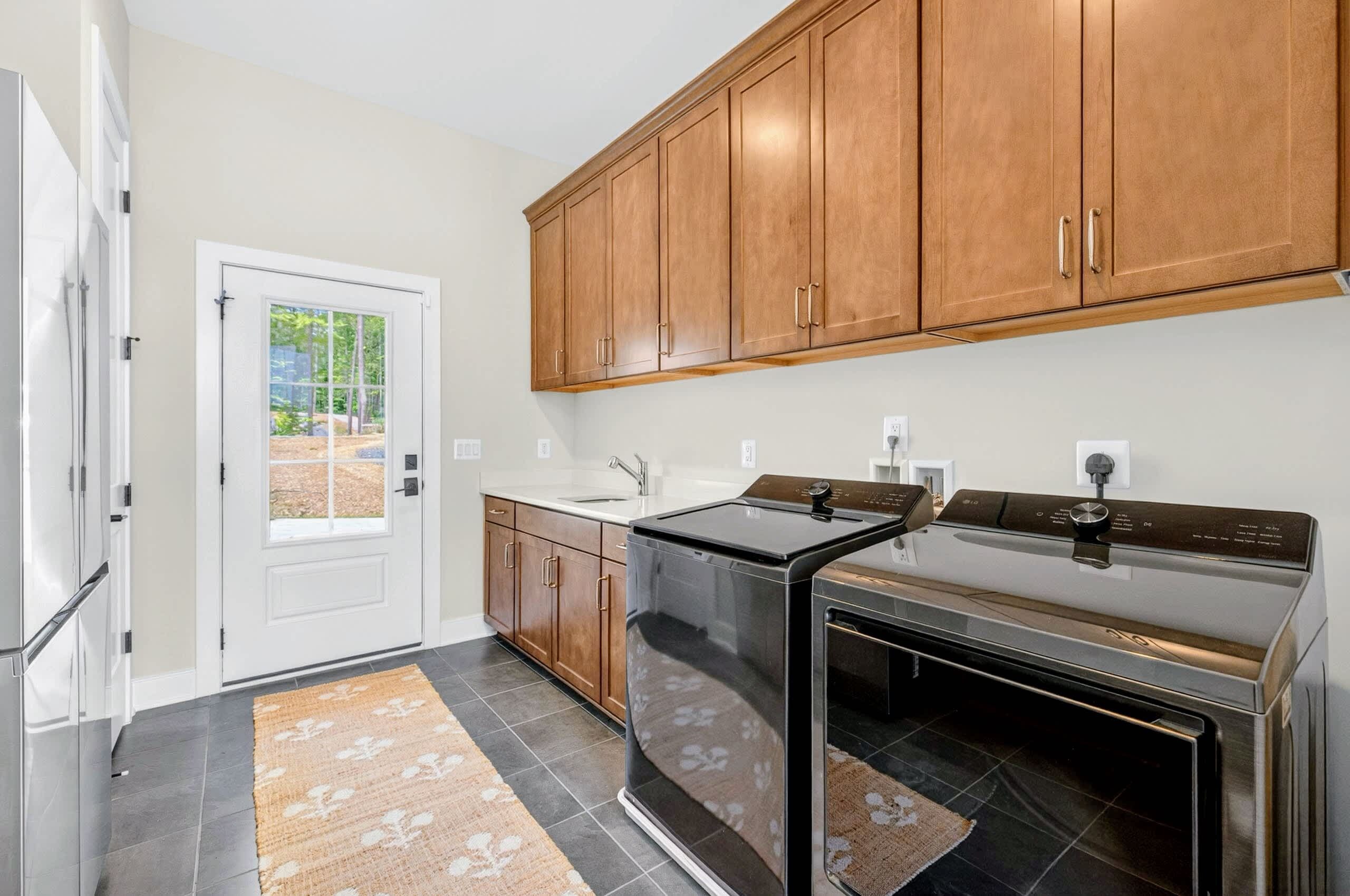 A kitchen with wooden cabinets, a stove, and a dishwasher.