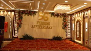 A room with a large number '56' signifying a wedding anniversary, a red carpet, and ornate wall decorations. - S S RESIDENCY (Gorakhpur)