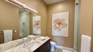 A modern bathroom with a marble vanity, a large mirror, a toilet, and a shower. - Sawtooth Sunsets in Stanley, Idaho (Stanley)