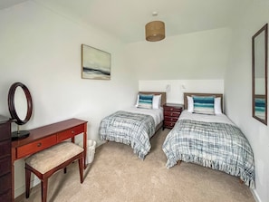 A bedroom with two beds, a desk, a mirror, and a painting on the wall. - 3 bedroom accommodation in Roag, near Dunvegan (Roag, near Dunvegan)